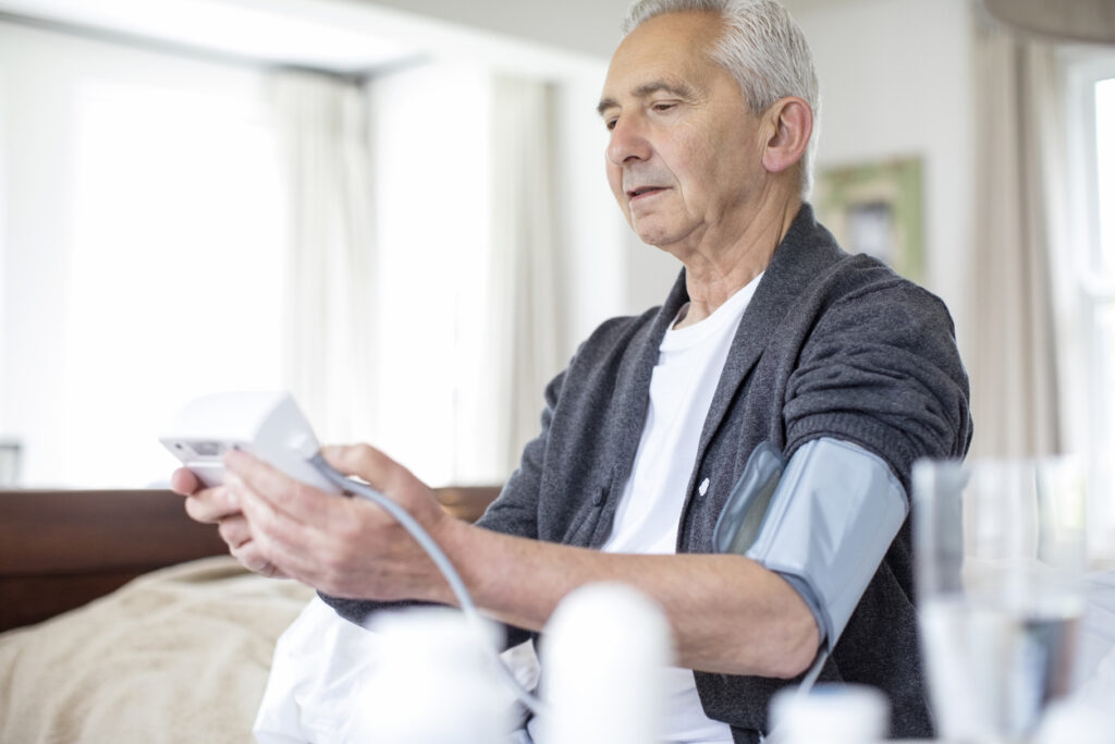 Image of man checking his blood pressure