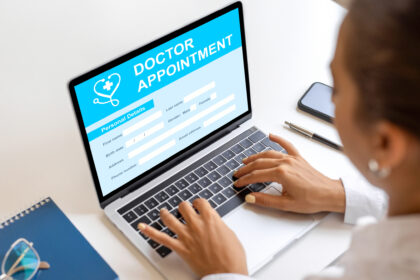 A patient uses a laptop to book a GP appointment