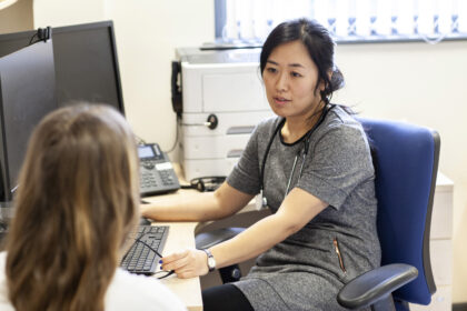 Female GP and patient in consulting room